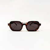 Sunglasses with tortoiseshell frame and dark lenses