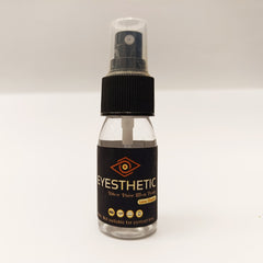 Clear spray bottle with black label on a white background